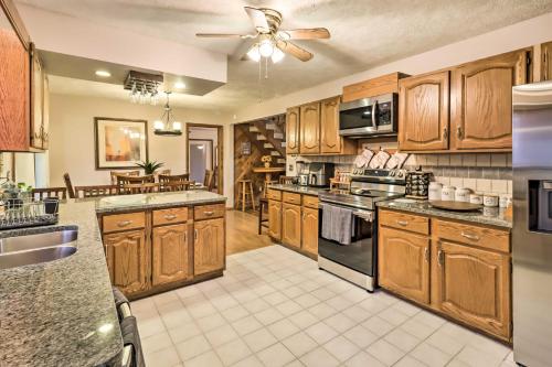 a large kitchen with wooden cabinets and a ceiling fan at Near Big Boulder Mtn Cabin with Furnished Deck in Albrightsville