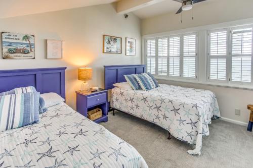 a bedroom with two beds and a window at Salt and Light Oceanfront Condo with Pool and Elevator in Ocean Isle Beach