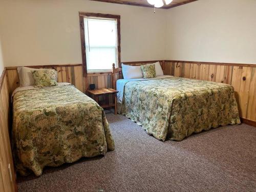a bedroom with two beds and a window at Solarium Cabin #16 on Patoka Lake in Southern Indiana in Seymour