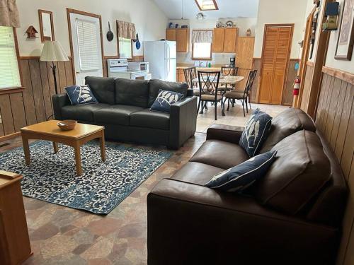 a living room with a couch and a table at Solarium Cabin #16 on Patoka Lake in Southern Indiana in Seymour