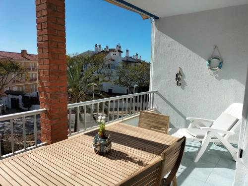 a deck with a table and chairs on a balcony at ApartiaBeach Apartamentos in Alcossebre