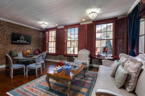 a living room with a couch and a table at The Alexandre in New Orleans