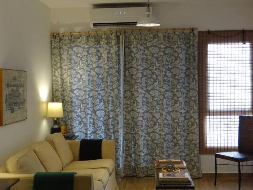 un soggiorno con un divano e una finestra di Best location ! Apt privado 2 hab con AC Completamente equipado en Asuncion ad Asunción