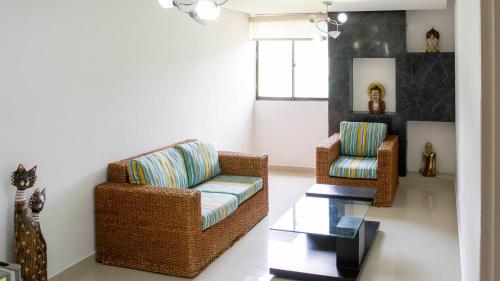 a living room with two chairs and a table at Hotel San Juan Internacional in Bucaramanga