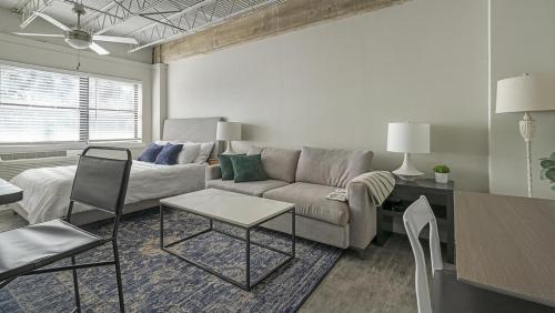 a living room with a couch and a table at Landing Modern Apartment with Amazing Amenities (ID1803X66) in Mobile