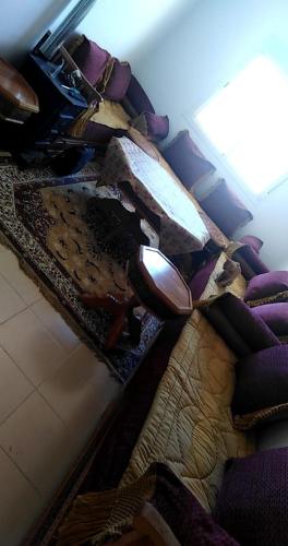 a pair of shoes sitting on a table with a rug at Appartement Jardin d'Ifrane in Ifrane