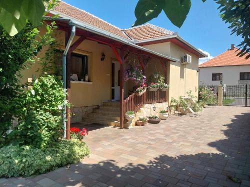 a house with a porch with potted plants at Lipták Vendégház in Tokaj