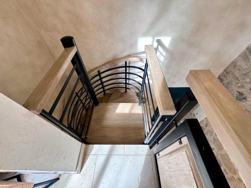 a spiral staircase in a building with a wooden floor at Loft Amalfi en Val'Quirico in Santeagueda