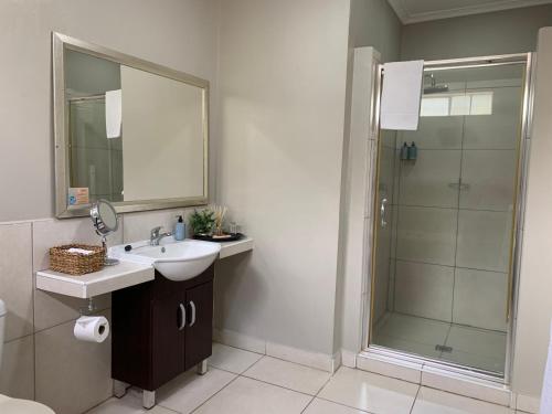 a bathroom with a sink and a shower at The Leslie - Bed & Breakfast in Blantyre