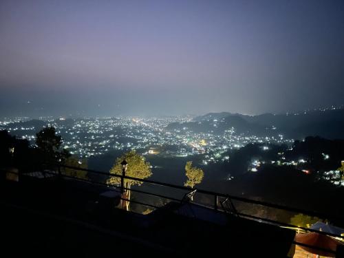 Blick auf die Stadt in der Nacht in der Unterkunft Himalaya Serene View Guest House & Farm Stay in Deorāli