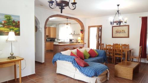 a living room with a couch and a kitchen at Los Olivos in Málaga