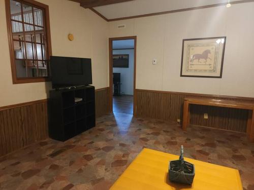 a living room with a television and a table at Family Style Home #22 on Patoka Lake in Southern Indiana in Eckerty