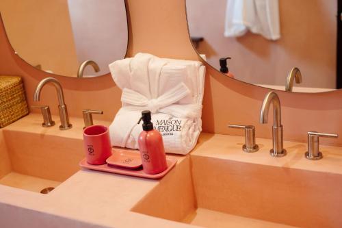 a bathroom with two sinks and a mirror at Maison Mexique Hotel Boutique San Miguel de Allende in San Miguel de Allende