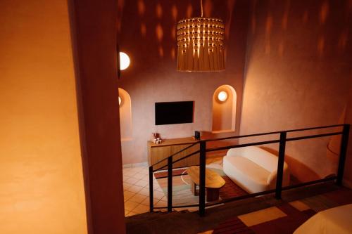 a hotel room with a bed and a chandelier at Maison Mexique Hotel Boutique San Miguel de Allende in San Miguel de Allende