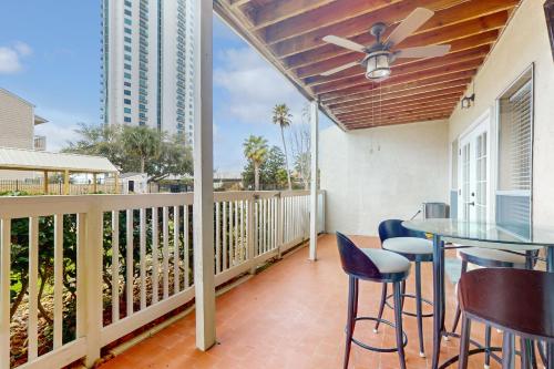 a patio with a table and chairs on a balcony at Mariner Village 108 in Seabrook