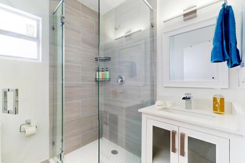 a bathroom with a shower and a sink at Hallandale Haven in Hallandale Beach