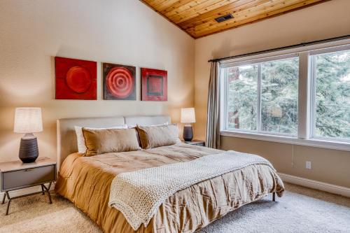 a bedroom with a bed and a large window at Canterbury Lodge in Kings Beach