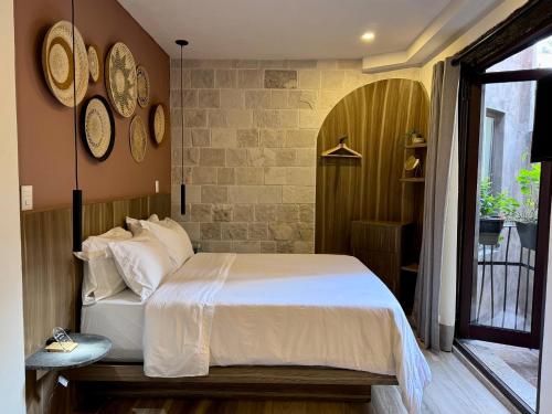 a bedroom with a bed and clocks on the wall at Val'Quirico Lucca 84 Loft Toscano in Santeagueda