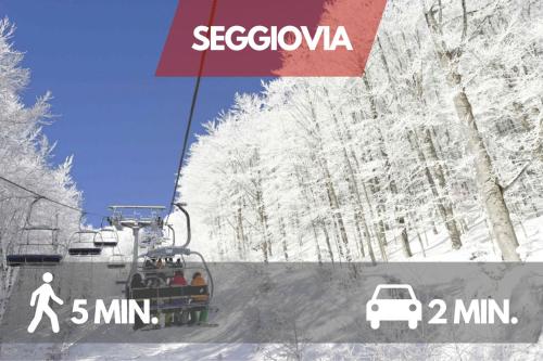 a ski lift with people on it in the snow at Centro Storico Sestola Wifi e Netflix in Sestola