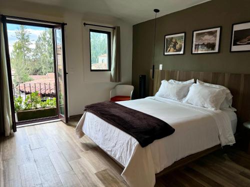 a bedroom with a large bed and a large window at Loft Arezzo Val'Quirico in Santeagueda
