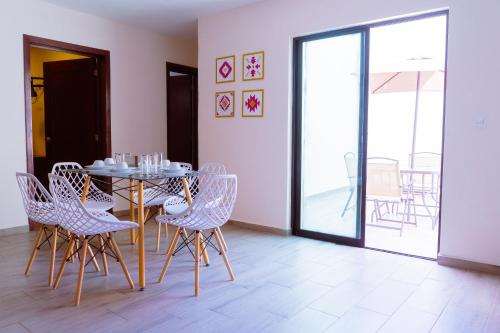 a dining room with a table and chairs at Santa Martha Bungalows in Los Ayala