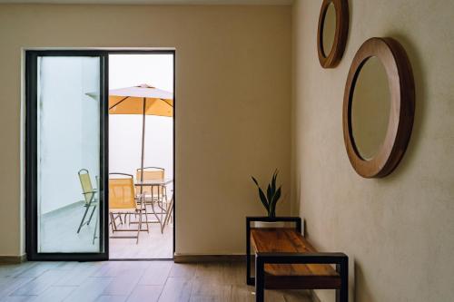 a room with a table and a mirror on the wall at Santa Martha Bungalows in Los Ayala