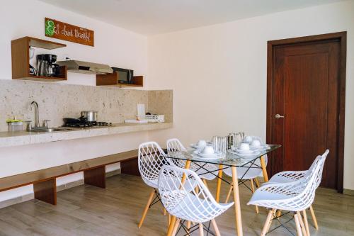 a kitchen with a table and chairs and a counter at Santa Martha Bungalows in Los Ayala