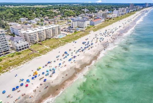 an aerial view of a beach with people and umbrellas at Family friendly spacious Barefoot townhome in North Myrtle Beach