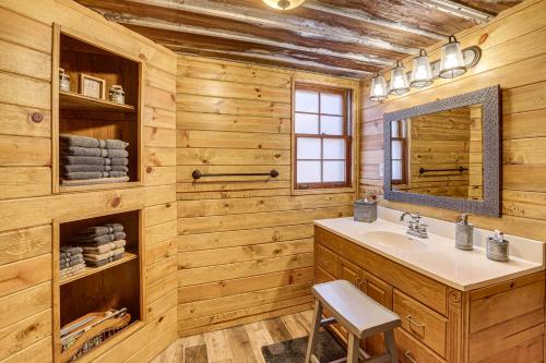 a bathroom with a sink and a mirror at Cropwell Cabin with Fire Pit, Near Logan Martin Lake 