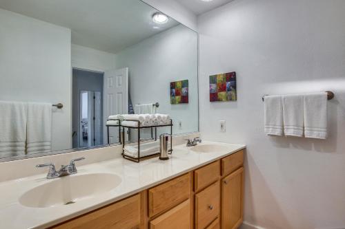 a bathroom with a sink and a large mirror at St Ann Townhome Less Than 1 Mi to International Airport! in Edmundson