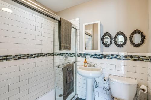 a white bathroom with a sink and a shower at Pet-Friendly Apartment 1 Mi to Lake Merritt! in Oakland