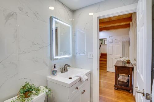 uma casa de banho branca com um lavatório e um espelho em Modern Kirkland Home with Sauna and Outdoor Fireplace em Kirkland