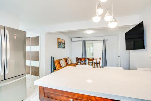 a kitchen and living room with a refrigerator at Ewa Beach Apartment with Beach Gear about 1 Mi to Ocean! in Kapolei
