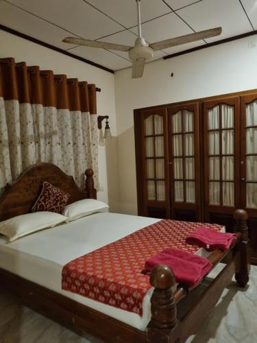 a bedroom with a large bed in a room at JAYANDRA HOLIDAY BUNGALOW in Waga