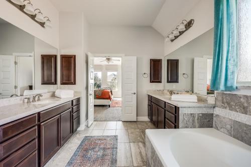 a bathroom with two sinks and two mirrors at Immaculate, family friendly home in SW Austin in Austin
