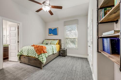 a bedroom with a bed and a ceiling fan at Immaculate, family friendly home in SW Austin in Austin