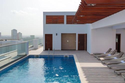 a swimming pool on the roof of a building at Luxury Studio Suite at The Gallery in Accra