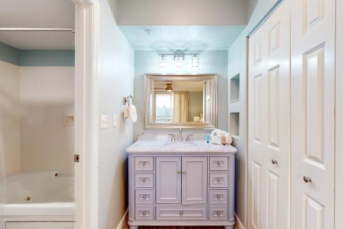 a bathroom with a sink and a mirror at The Terrace at Pelican Beach 304 in Destin