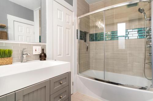 a bathroom with a white sink and a shower at Reno Family Escape: Cozy 4BR Netflix Wi-Fi in Reno