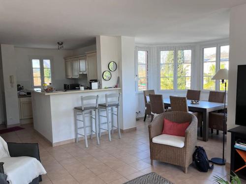 eine Küche und ein Wohnzimmer mit einem Tisch und Stühlen in der Unterkunft Charmante Maison T3 Parking, Clim, Front de Mer in Grimaud