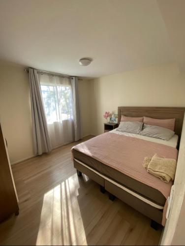a bedroom with a large bed and a window at Dpto. Con excelente ubicación in Santiago