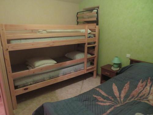 two bunk beds in a room with a bed at Gite Les hippocampes in Saint-Germain-de-Marencennes