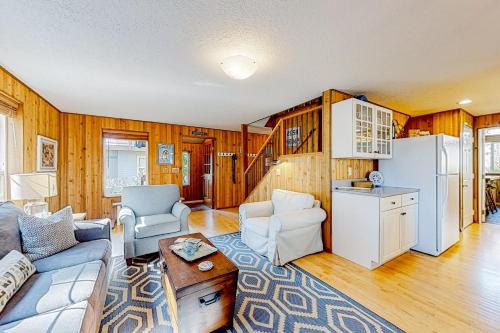 a living room with a couch and a refrigerator at Comfy Cabin by the Sea in Nehalem