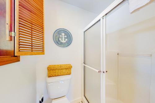 a bathroom with a toilet and a shower at Comfy Cabin by the Sea in Nehalem