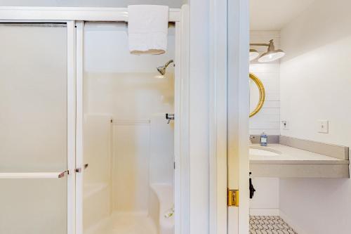 a bathroom with a shower and a sink at Comfy Cabin by the Sea in Nehalem