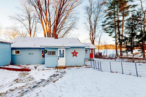 a small blue house with a red star on it in the snow at Castleton Charmer in Castleton