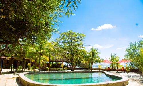 a pool in the middle of a resort with trees at Casa Playa San Diego in San Diego