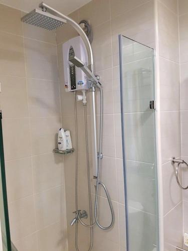 a shower with a shower head in a bathroom at Blowing In The Wind in Tagaytay