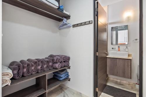 łazienka z umywalką i półką z ręcznikami w obiekcie Coastal Comfort Haven w mieście Nuevo Vallarta