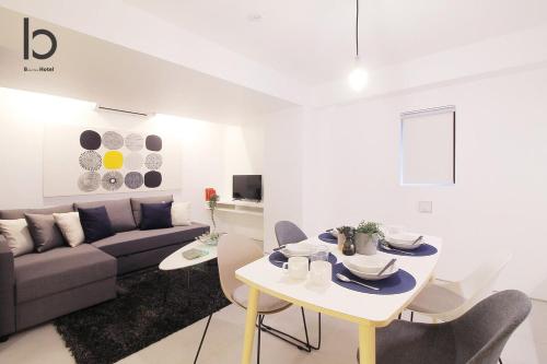 a living room with a couch and a table at b hotel Heiwaodori 202 - New Apt Famous Hiroshima Hondori for 6p in Hiroshima